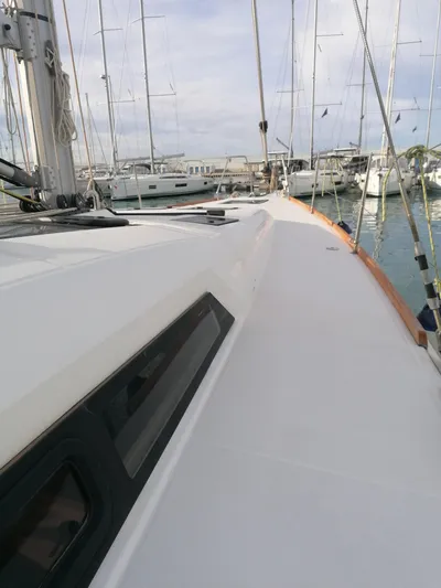  Yacht Photos Pics 2019 Dufour 460 Grand Large sailboat docked in a marina, showcasing sleek deck design.