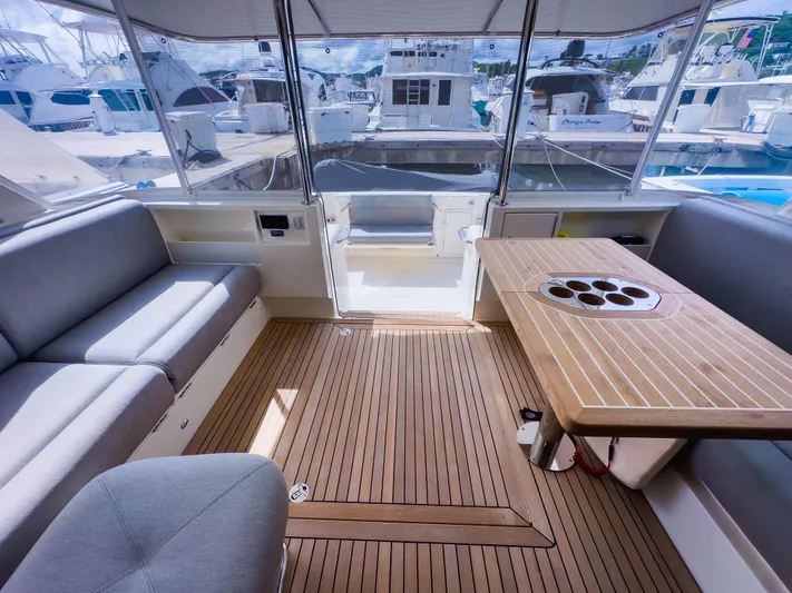  Yacht Photos Pics Luxurious 2024 Riviera SMY 46 yacht interior with elegant seating and wooden table.