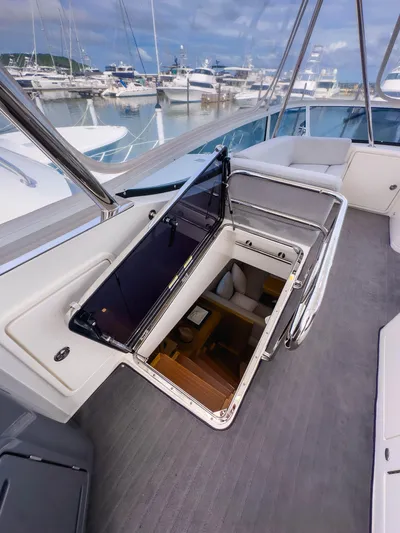  Yacht Photos Pics 2024 Riviera SMY 46 yacht interior with open hatch, showcasing luxurious design and marina view.