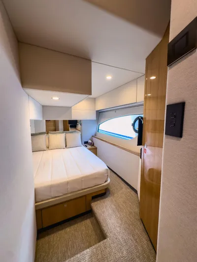  Yacht Photos Pics Luxurious bedroom interior of 2024 Riviera SMY 46 yacht with modern design.