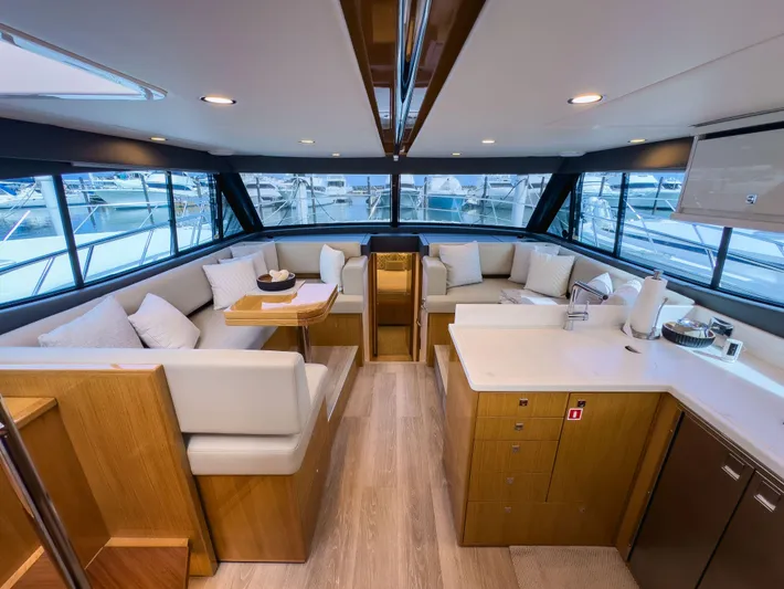  Yacht Photos Pics Luxurious interior of 2024 Riviera SMY 46 yacht with modern seating and panoramic windows.