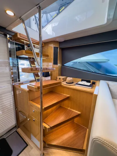  Yacht Photos Pics 2024 Riviera SMY 46 yacht interior with wooden stairs and modern design elements.