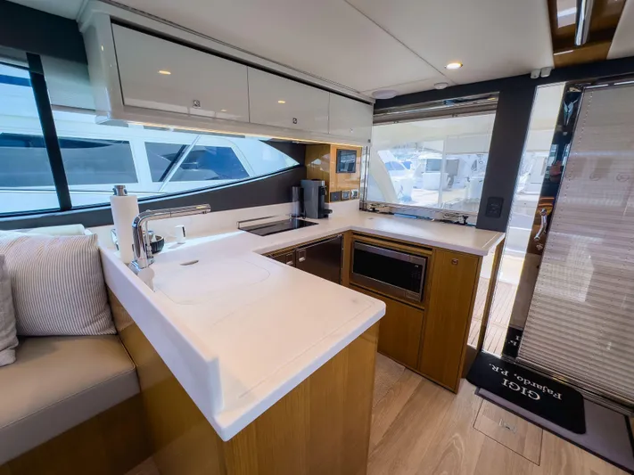  Yacht Photos Pics Modern kitchen interior of 2024 Riviera SMY 46 yacht with sleek countertops and appliances.