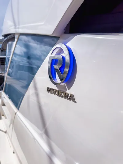  Yacht Photos Pics 2024 Riviera SMY 46 yacht with sleek design and logo detail.