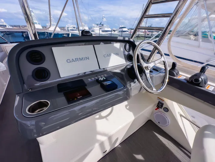  Yacht Photos Pics 2024 Riviera SMY 46 helm with Garmin displays and modern steering wheel.