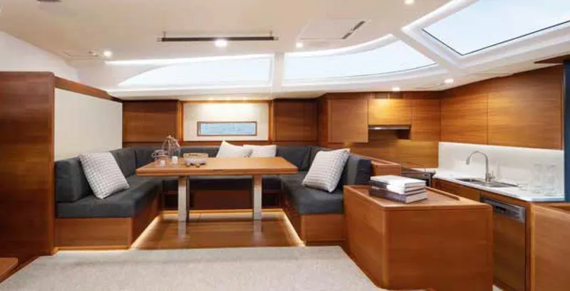 Yacht Photos Pics Luxurious interior of 2019 Solaris 64RS yacht with elegant wood finish and modern seating area.