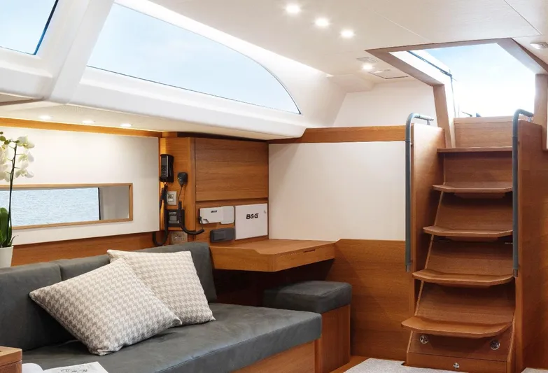  Yacht Photos Pics Luxurious interior of 2019 Solaris 64RS yacht with modern wood finish and comfortable seating.
