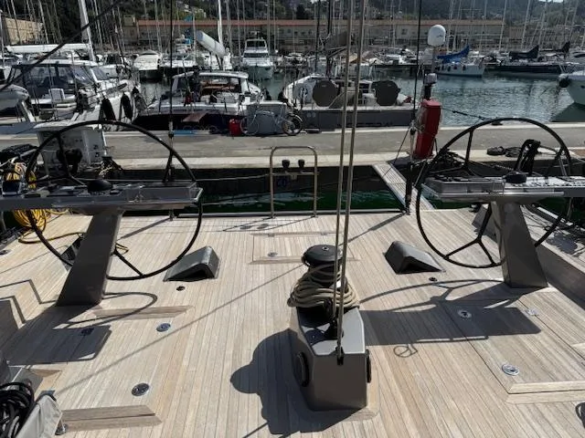  Yacht Photos Pics 2019 Solaris 64RS yacht deck with dual steering wheels in a marina setting.