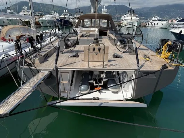  Yacht Photos Pics 2019 Solaris 64RS yacht with lifting keel docked in marina, showcasing sleek design and spacious deck.