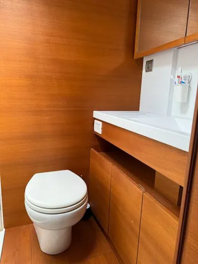  Yacht Photos Pics Modern bathroom in 2019 Solaris 64RS yacht with wooden cabinetry and sleek fixtures.