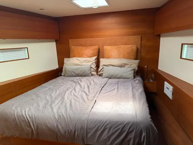  Yacht Photos Pics Luxurious cabin interior of 2019 Solaris 64RS yacht with cozy double bed and wooden finish.