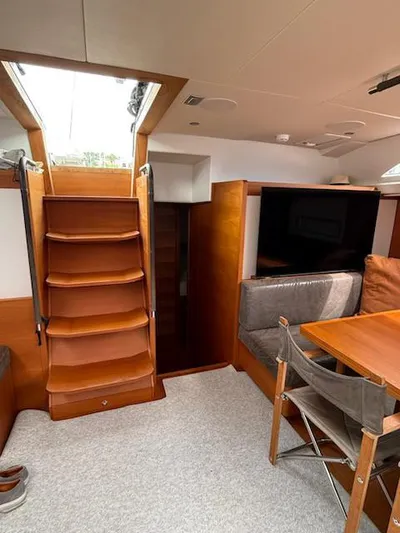  Yacht Photos Pics Interior of 2019 Solaris 64RS yacht with wooden stairs and dining area.