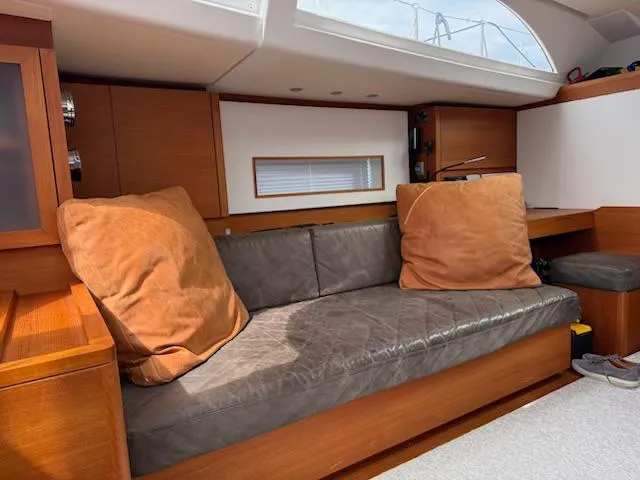  Yacht Photos Pics Luxurious interior of 2019 Solaris 64RS yacht with leather sofa and wooden accents.
