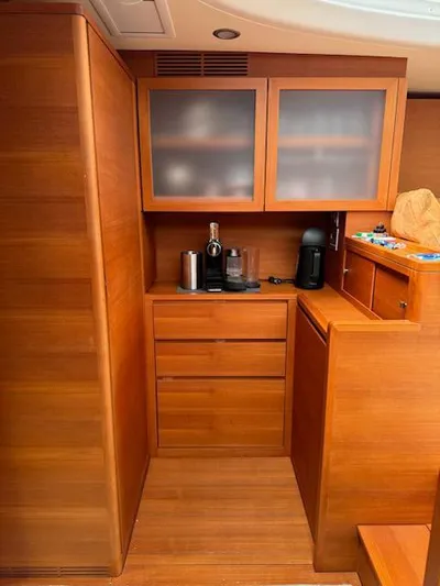  Yacht Photos Pics Wooden interior of 2019 Solaris 64RS yacht kitchen with cabinets and appliances.
