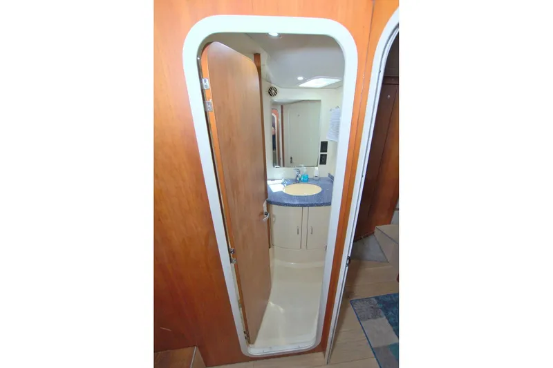 Fish Daddy Yacht Photos Pics 1998 Luhrs 36 Convertible yacht bathroom with wooden door and modern sink.