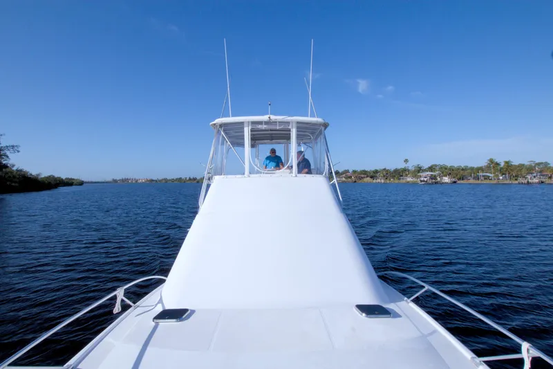 Fish Daddy Yacht Photos Pics 1998 Luhrs 36 Convertible yacht cruising on a calm blue waterway under clear skies.