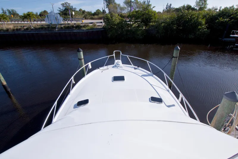 Fish Daddy Yacht Photos Pics 1998 Luhrs 36 Convertible boat docked, viewed from above, with calm water and greenery.