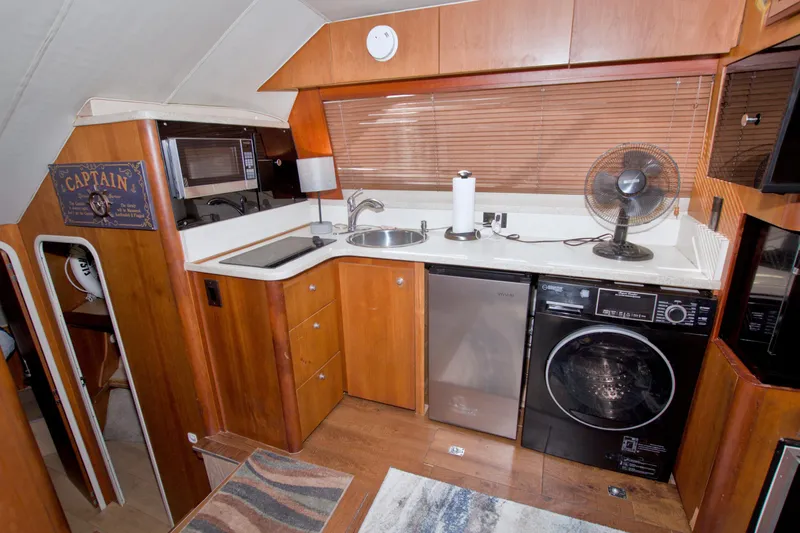 Fish Daddy Yacht Photos Pics 1998 Luhrs 36 Convertible yacht kitchen with appliances and wooden cabinetry.