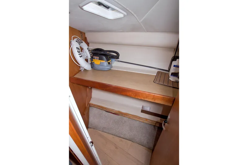 Fish Daddy Yacht Photos Pics Storage area inside 1998 Luhrs 36 Convertible boat with life preserver and vacuum.