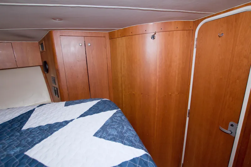 Fish Daddy Yacht Photos Pics Interior cabin of 1998 Luhrs 36 Convertible with wood paneling and bed.
