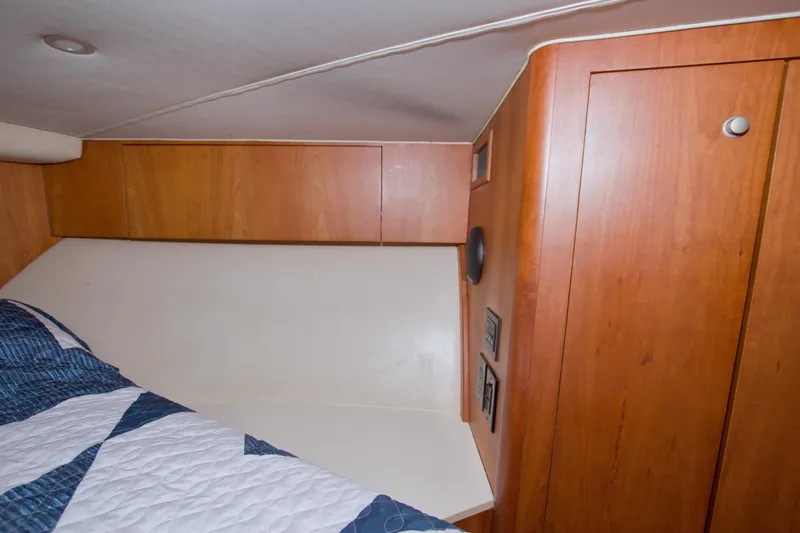 Fish Daddy Yacht Photos Pics 1998 Luhrs 36 Convertible cabin interior with wood paneling and bed.
