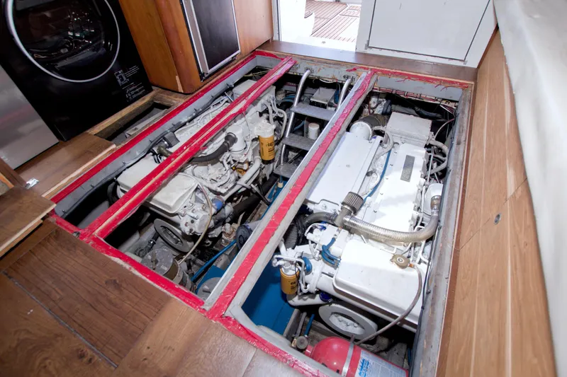 Fish Daddy Yacht Photos Pics Engine room of 1998 Luhrs 36 Convertible boat, showcasing dual engines and wooden flooring.