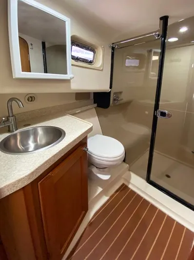 Sandpiper Yacht Photos Pics Bathroom interior of a 2004 Mainship 340 yacht with sink, toilet, and shower.