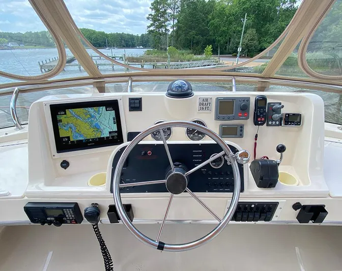 Sandpiper Yacht Photos Pics Helm of 2004 Mainship 340 boat with navigation equipment and steering wheel.