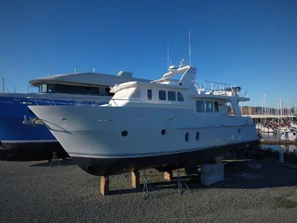 Suspense Yacht Photos Pics 2005 Inace Trawler yacht on dry dock, clear sky background.