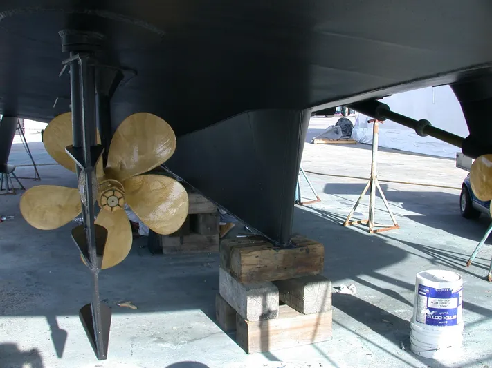 Suspense Yacht Photos Pics Underwater view of a 2005 Inace Trawler's propeller and rudder in dry dock.