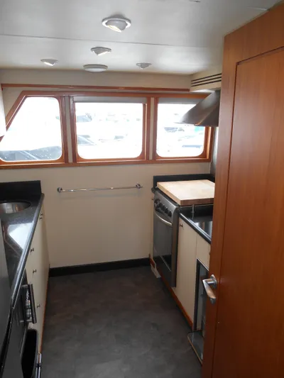 Suspense Yacht Photos Pics 2005 Inace Trawler kitchen interior with modern appliances and wood accents.