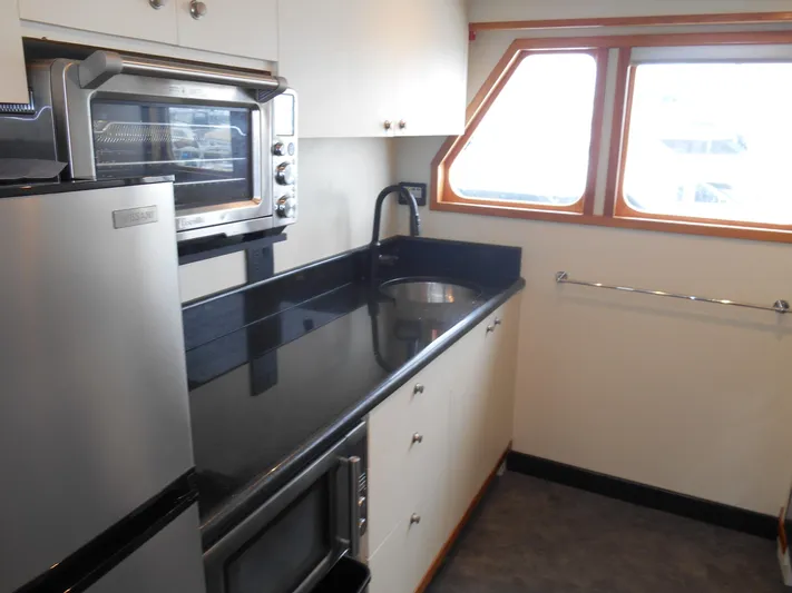 Suspense Yacht Photos Pics Kitchen area of a 2005 Inace Trawler with modern appliances and sleek countertops.