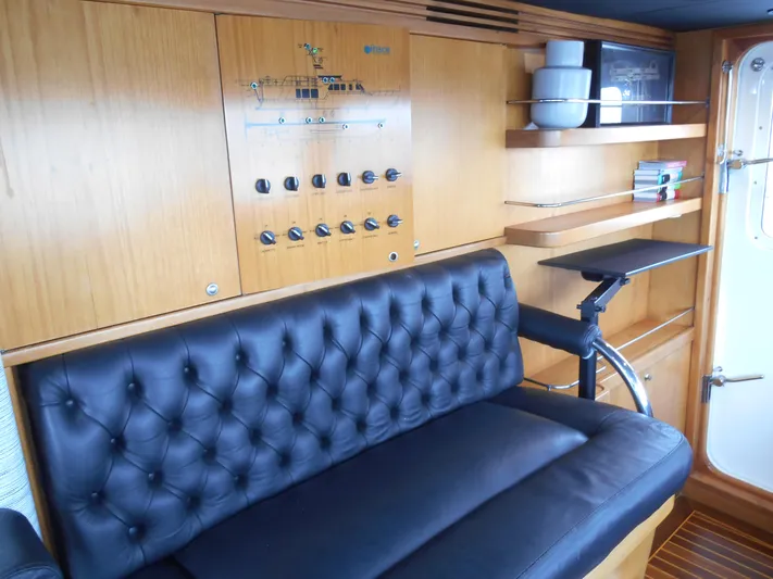 Suspense Yacht Photos Pics Luxurious 2005 Inace Trawler interior with leather seating and wooden paneling.