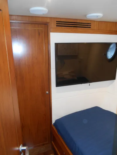 Suspense Yacht Photos Pics 2005 Inace Trawler cabin with wood paneling and mounted TV.