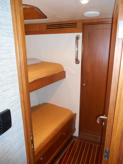 Suspense Yacht Photos Pics 2005 Inace Trawler cabin with wooden bunk beds and door.