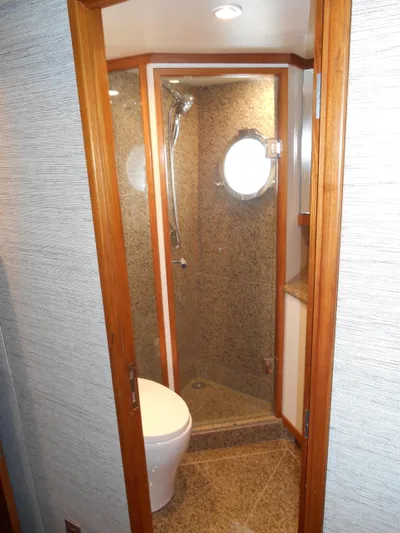 Suspense Yacht Photos Pics Bathroom interior of 2005 Inace Trawler with shower and porthole window.