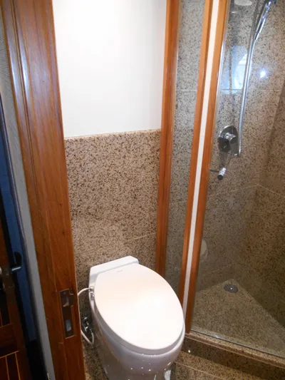 Suspense Yacht Photos Pics Bathroom interior of 2005 Inace Trawler with shower and toilet.