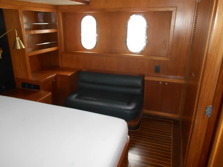 Suspense Yacht Photos Pics Luxurious 2005 Inace Trawler cabin with wood paneling and porthole windows.