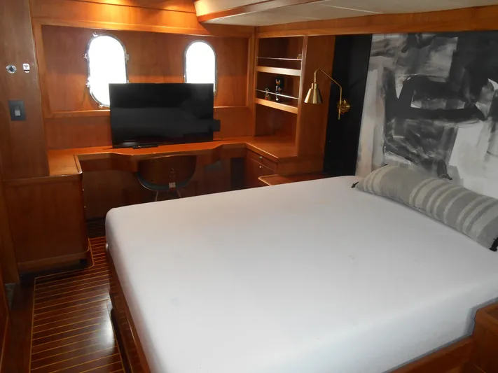 Suspense Yacht Photos Pics Luxurious 2005 Inace Trawler cabin with bed, TV, and wooden interior.