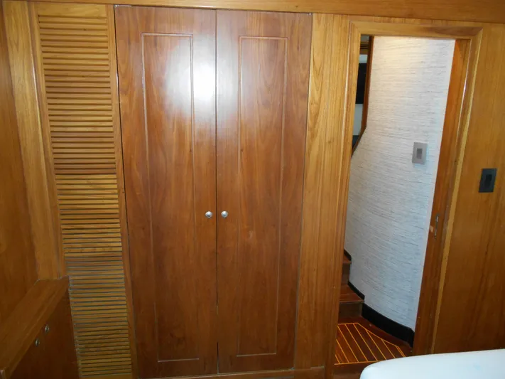 Suspense Yacht Photos Pics Wooden interior of 2005 Inace Trawler, featuring a closet and doorway.