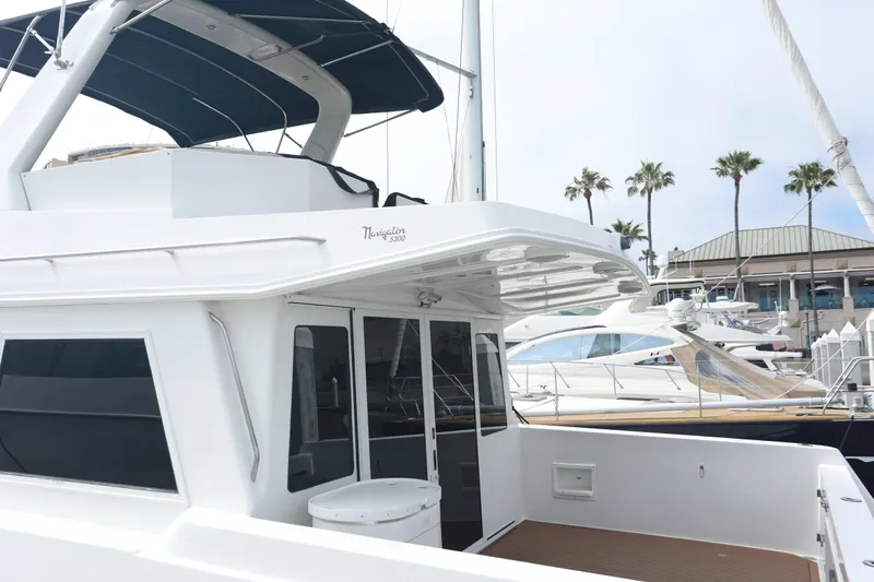 Ecto Boyz Yacht Photos Pics 2005 Navigator 53 Classic yacht docked at marina with palm trees in background.