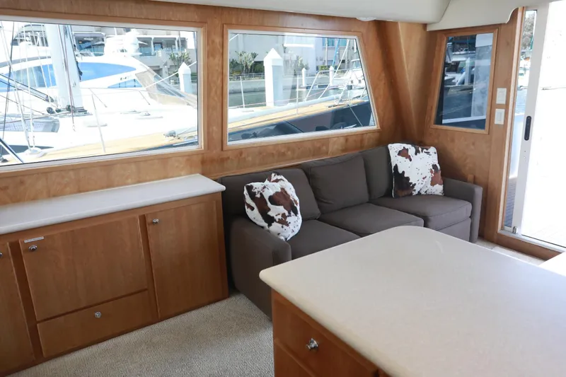 Ecto Boyz Yacht Photos Pics Interior of 2005 Navigator 53 Classic yacht with sofa, cushions, and wooden cabinetry.