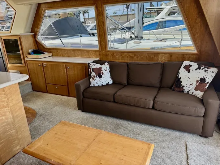 Ecto Boyz Yacht Photos Pics Interior of 2005 Navigator 53 Classic yacht with brown sofa and nautical decor.