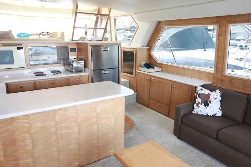 Ecto Boyz Yacht Photos Pics Interior of 2005 Navigator 53 Classic yacht with kitchen and seating area.