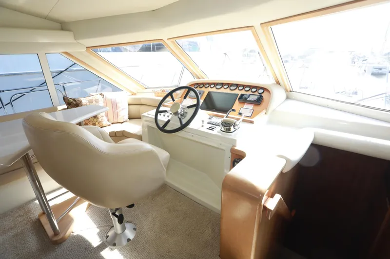 Ecto Boyz Yacht Photos Pics 2005 Navigator 53 Classic yacht helm with plush seating and panoramic windows.