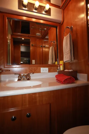 Ecto Boyz Yacht Photos Pics Luxurious bathroom in 2005 Navigator 53 Classic yacht with wooden cabinetry and elegant fixtures.