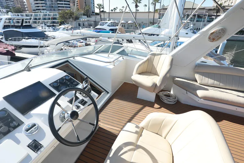 Ecto Boyz Yacht Photos Pics Luxurious 2005 Navigator 53 Classic yacht interior with steering wheel and plush seating at marina.