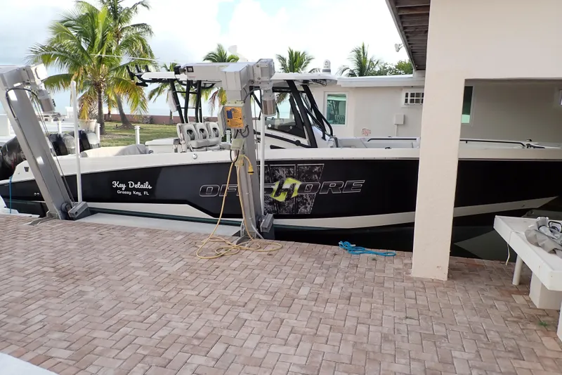  Yacht Photos Pics 2019 Wellcraft 352 Fisherman boat docked near a tropical setting with palm trees.