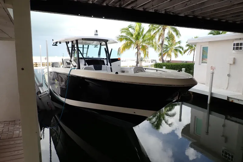  Yacht Photos Pics 2019 Wellcraft 352 Fisherman boat docked near palm trees and waterfront homes.