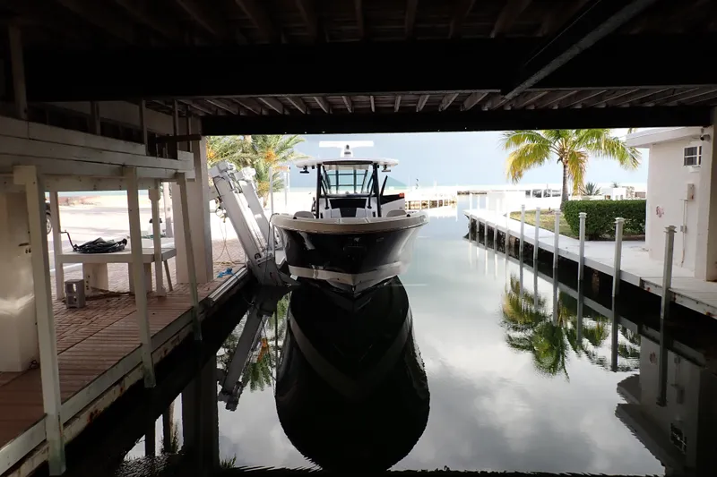  Yacht Photos Pics 2019 Wellcraft 352 Fisherman boat docked in a serene waterfront setting.